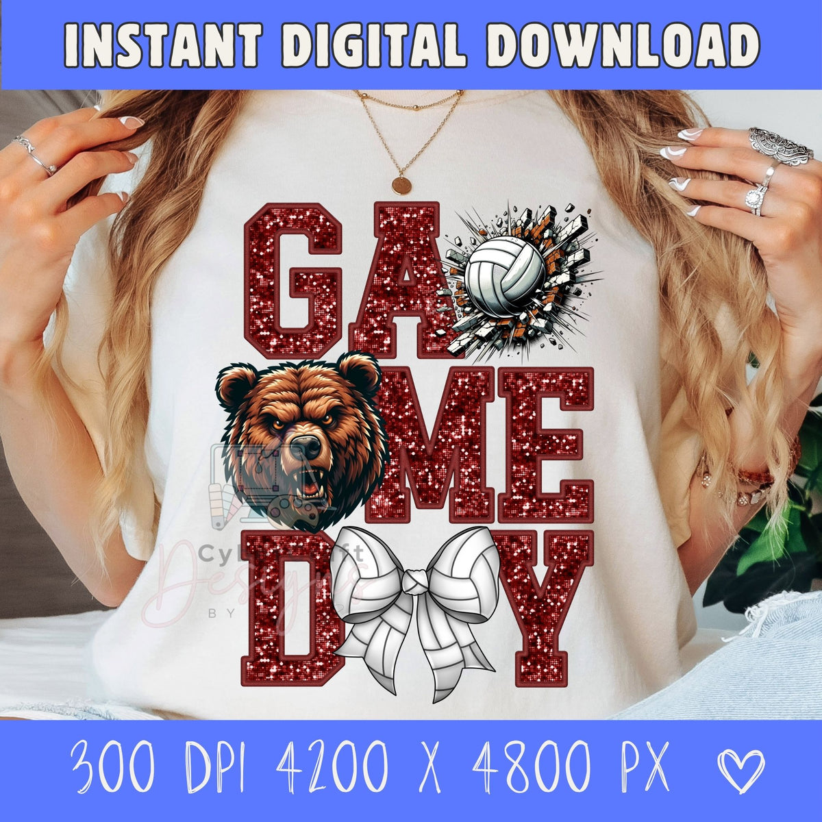 A person wearing a white graphic T-shirt with a glittery red 'GAME TIME' design, a bear face graphic, a volleyball, and a white ribbon motif. The photo is cropped from the shoulders to the torso, with hands visible on both sides.