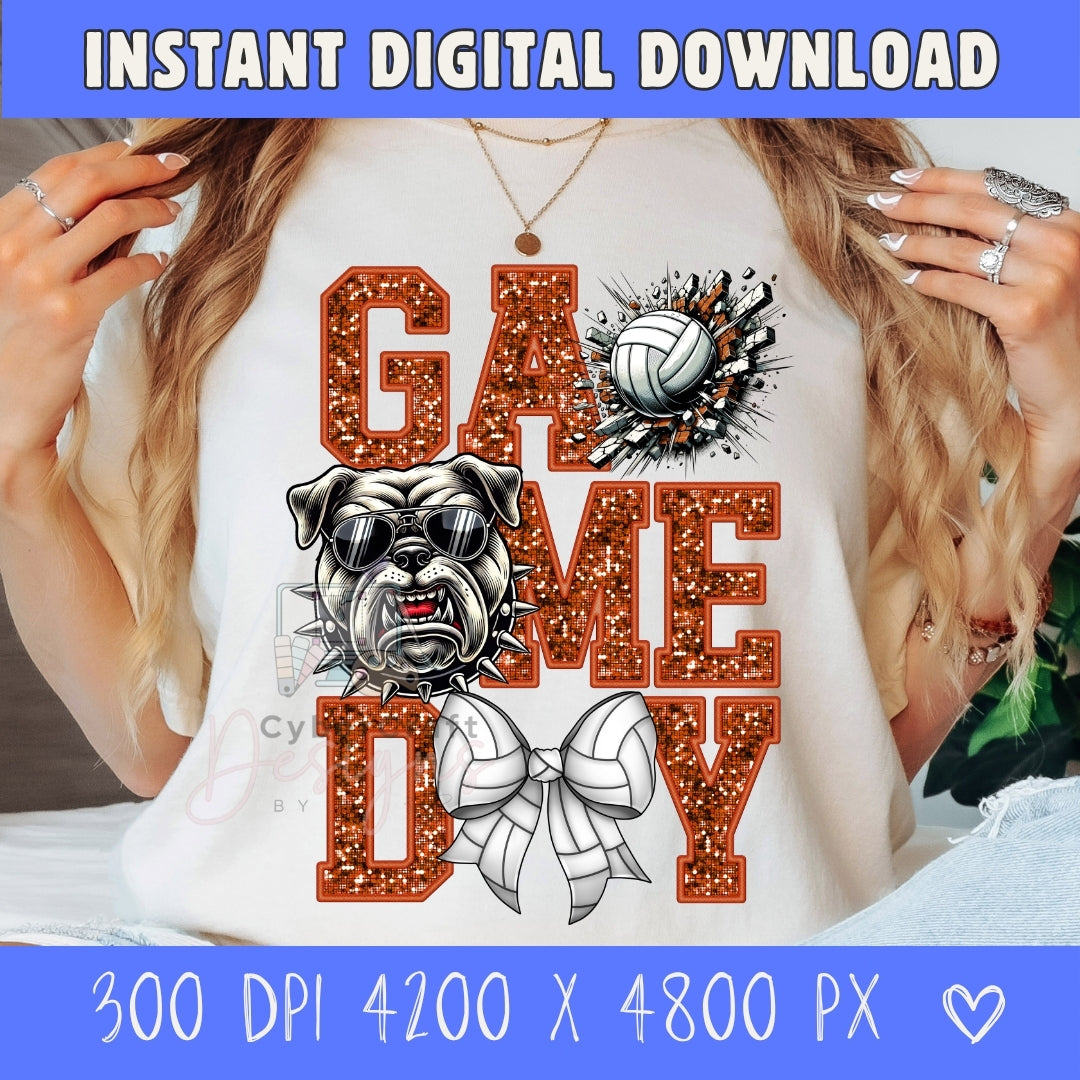 A person wearing a white graphic T-shirt with a glittery orange 'GAME DAY' design, a bulldog illustration, and a volleyball graphic. The photo is cropped from the shoulders to the torso, with hands visible on both sides.