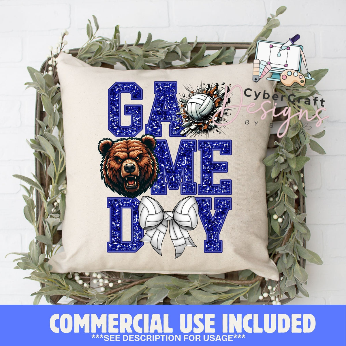 A square beige throw pillow with a 'GAME DAY' volleyball graphic, styled in a decorative wooden basket with green foliage. The graphic features blue glitter-textured letters, a brown bear, and white volleyballs.