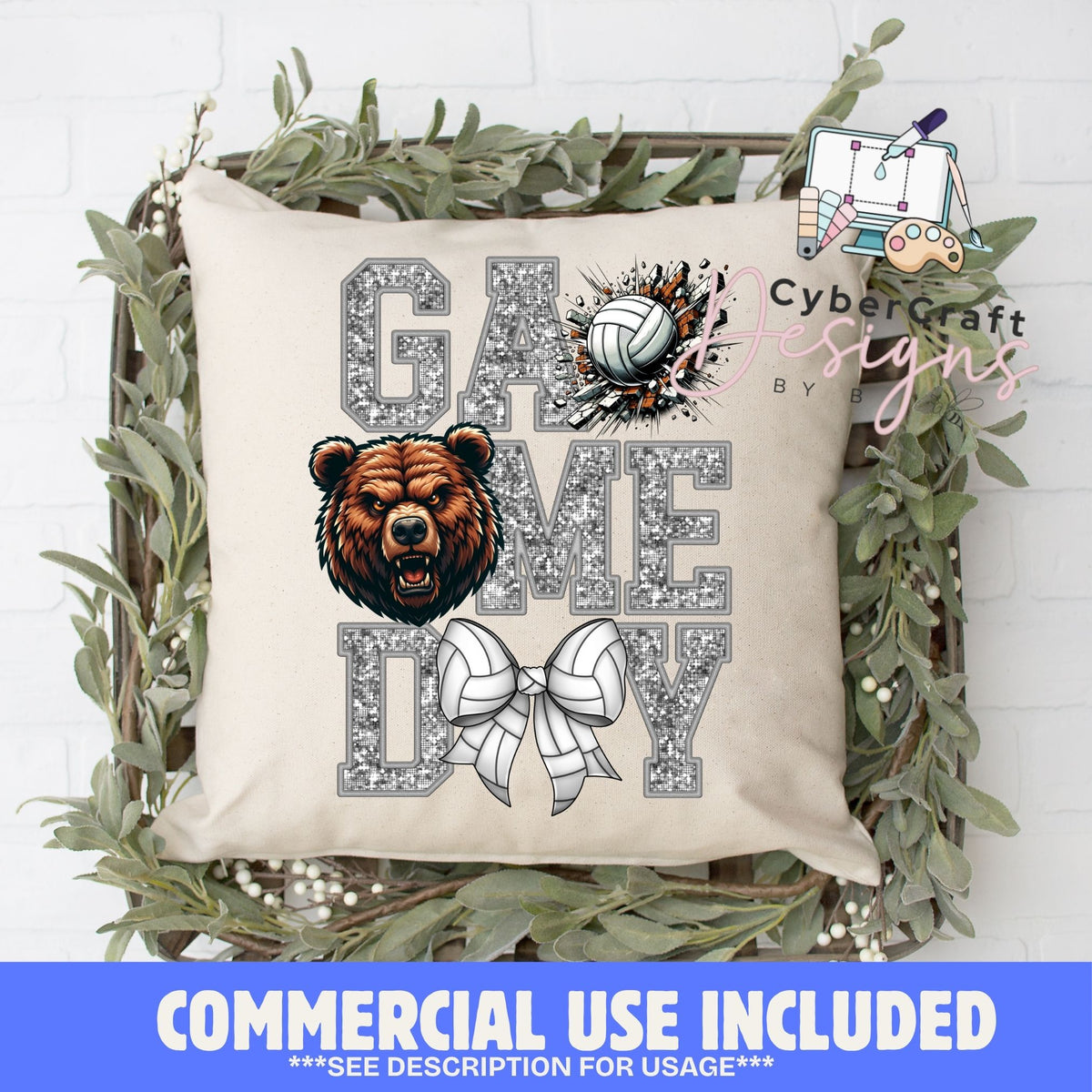 A square beige throw pillow with a 'Game Day' sports graphic featuring a brown bear head, volleyball, cheerleader bow, and glitter-textured lettering. The pillow is displayed in a rustic wooden crate decorated with green foliage, set against a white brick wall background.
