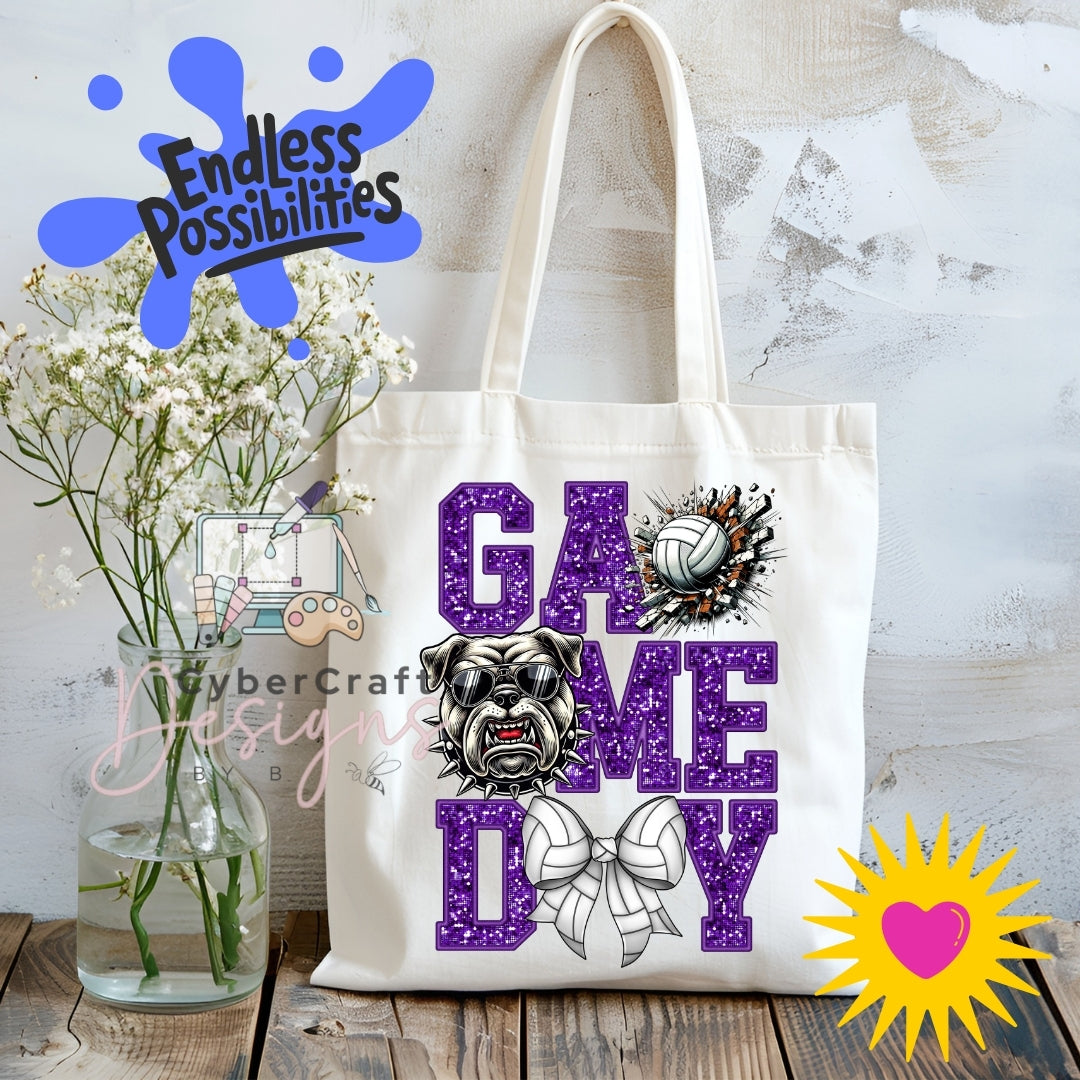 A cream canvas tote bag displayed on a rustic wooden surface against a textured white wall, decorated with a purple 'GAME DAY' graphic featuring a bulldog, a volleyball, and a bow. The bag is styled with a vase of baby's breath on the left and digital design overlays.