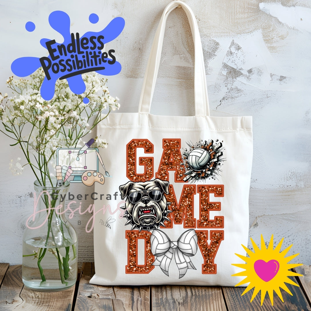 A white canvas tote bag with a 'Game Day' graphic featuring a bulldog, volleyball, and bow tie, displayed on a rustic wooden table next to a vase of baby's breath with decorative overlays.
