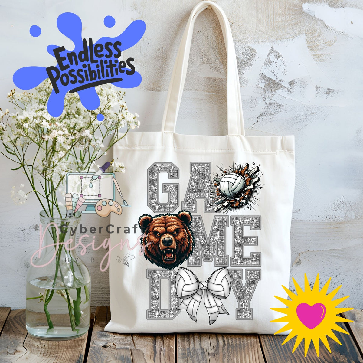 A white canvas tote bag with a 'Game Day' graphic featuring a bear head, volleyball, and bow, displayed on a rustic wooden table next to a vase of baby's breath with decorative overlays.