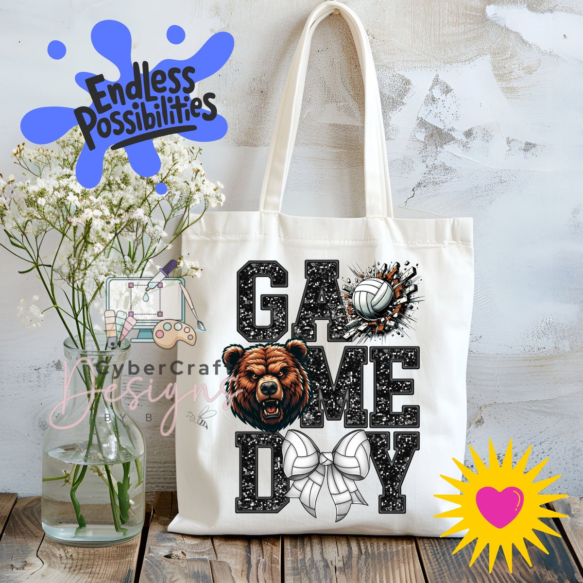 A white canvas tote bag with 'GAME DAY' printed in black distressed letters, featuring a bear head graphic, a volleyball, and a bow. The bag is displayed on a rustic wooden table next to a glass vase of baby's breath, with decorative digital overlays including 'Endless Possibilities' and 'CyberCraft Designs'.