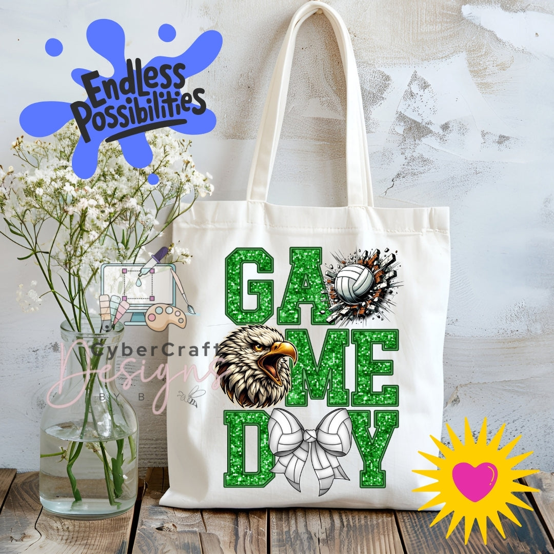 A cream canvas tote bag displayed on a rustic wooden table with white baby's breath flowers in a glass vase. The bag features a green glitter-textured 'GAME DAY' design with a bulldog graphic and a volleyball.