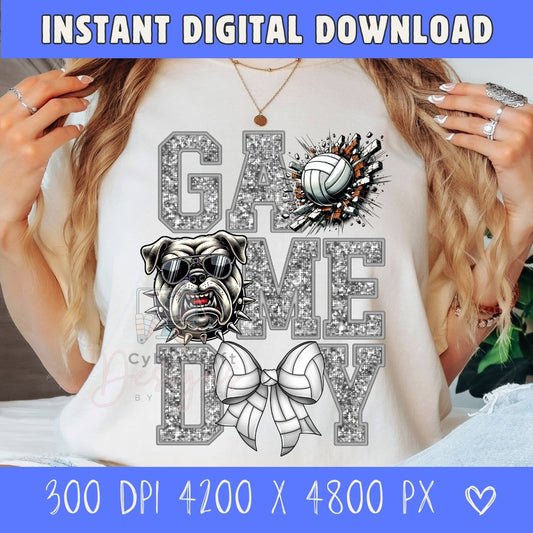 A woman wearing a white graphic t-shirt with a 'GAME A GAME DAY' design featuring a bulldog, volleyball, and bow tie in a glittery silver style. The image includes a blue banner at the top and bottom with text 'INSTANT DIGITAL DOWNLOAD' and print size details.