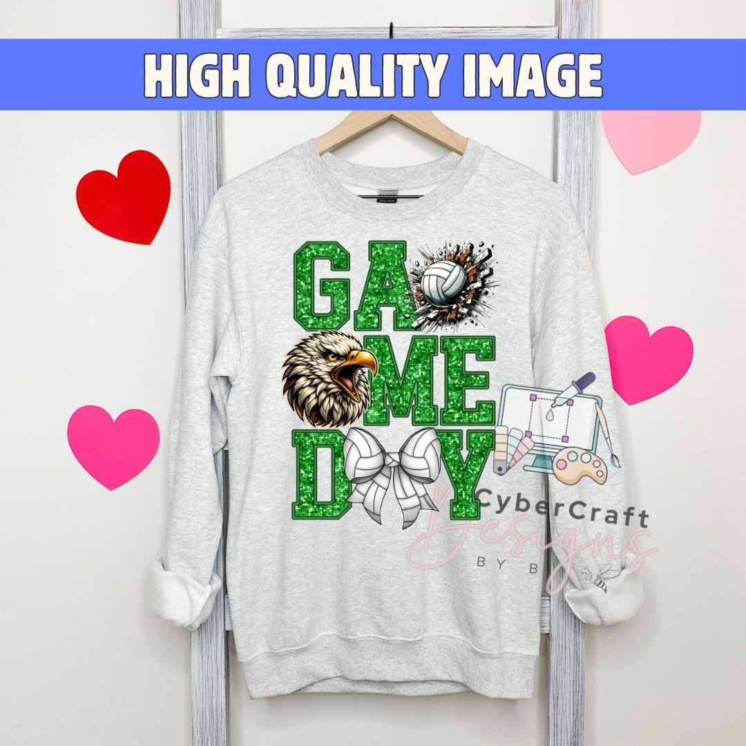 A light gray crewneck sweatshirt hanging on a wooden hanger, featuring a 'GAME DAY' graphic with a green glitter-textured football, a bald eagle, a volleyball, and a bow tie. The background is a white wall with pink and red heart graphics and a blue banner at the top reading 'HIGH QUALITY IMAGE'.