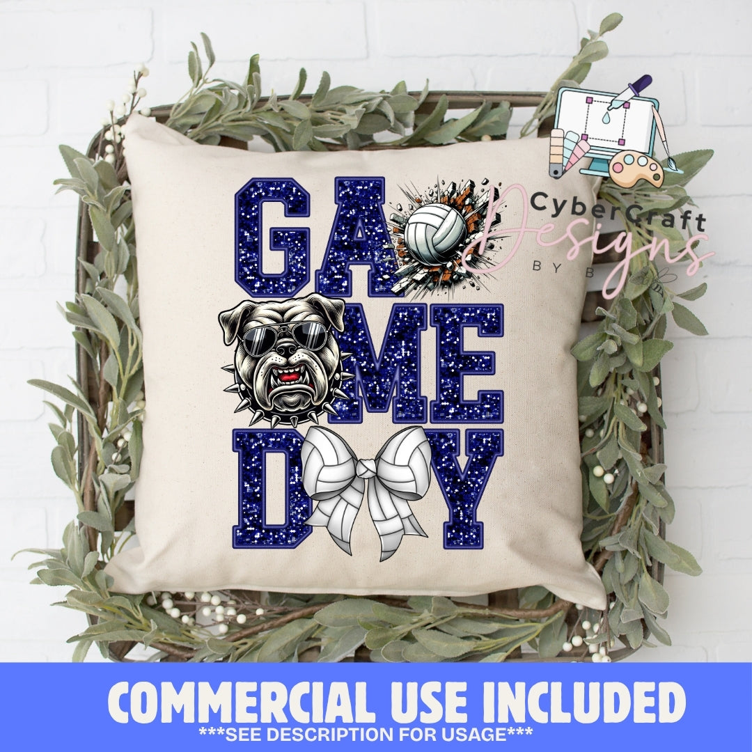 A square beige throw pillow with a navy blue and white 'GAME DAY' graphic featuring a bulldog, volleyball, and ribbon bow, displayed in a decorative wooden crate with greenery. A blue banner at the bottom reads 'COMMERCIAL USE INCLUDED'.
