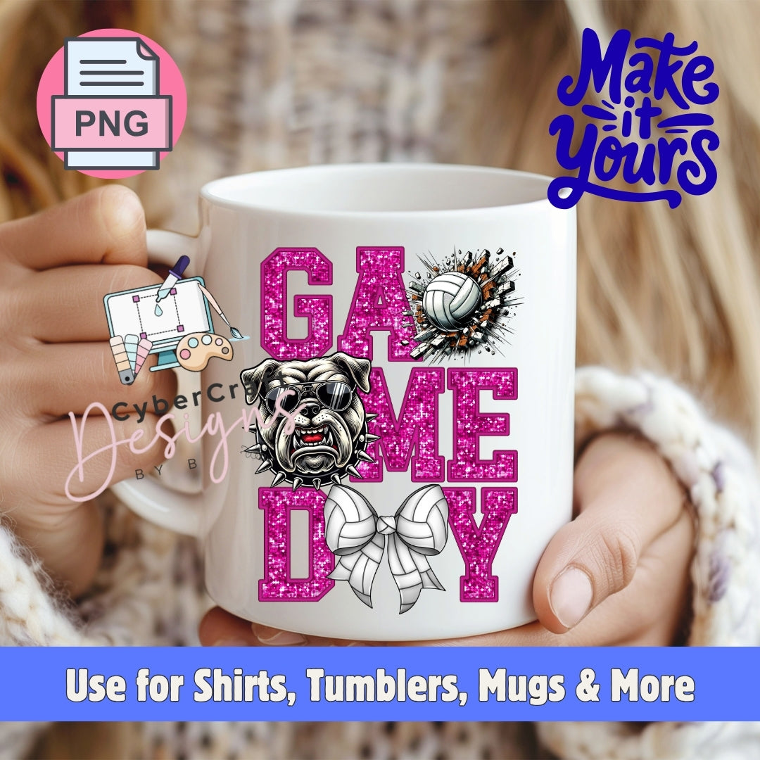 A white ceramic mug held by two hands, featuring a pink glitter-style 'GAME DAY' design with a bulldog illustration, a volleyball, and a bow tie. The background shows a blurred indoor setting with a person wearing a knit sweater.