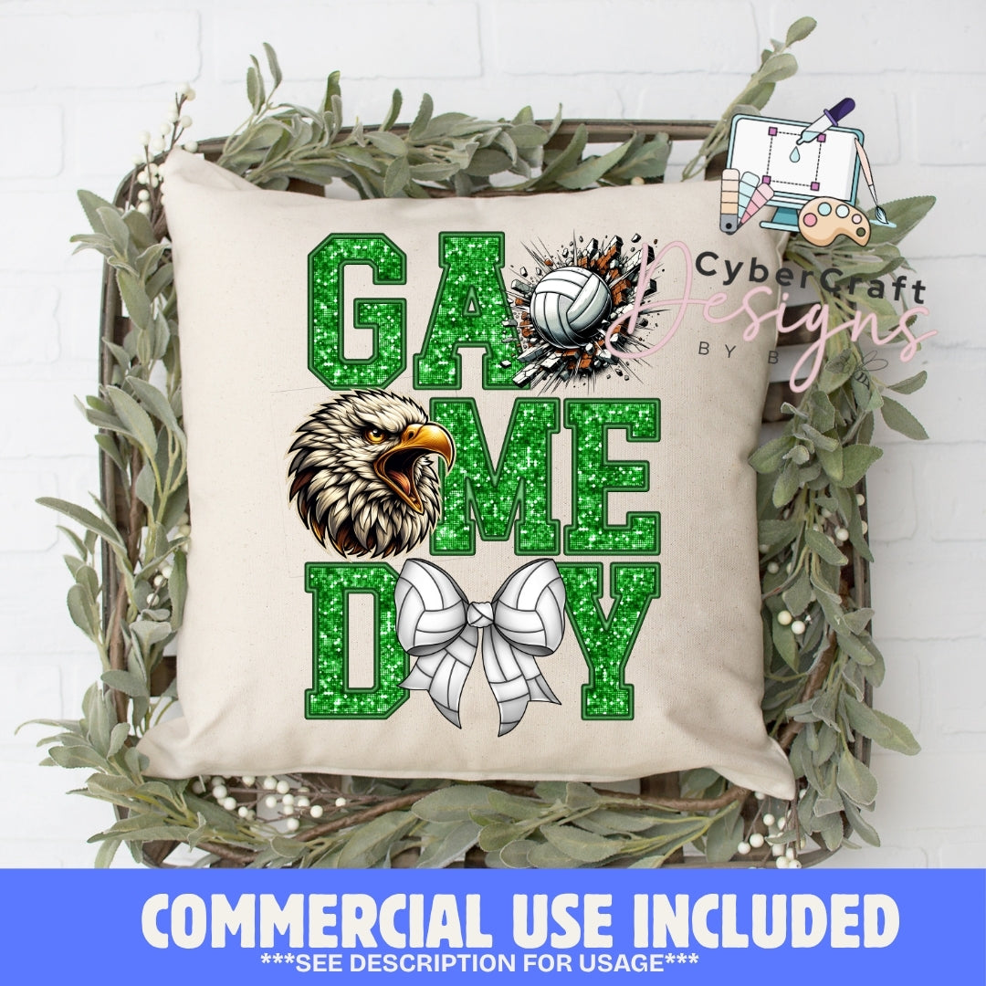 A square beige throw pillow with a green glitter-textured 'GAME TIME' design, featuring a volleyball graphic, an eagle illustration, and a white bow, displayed in a decorative wooden crate with greenery. A blue banner at the bottom reads 'COMMERCIAL USE INCLUDED'.
