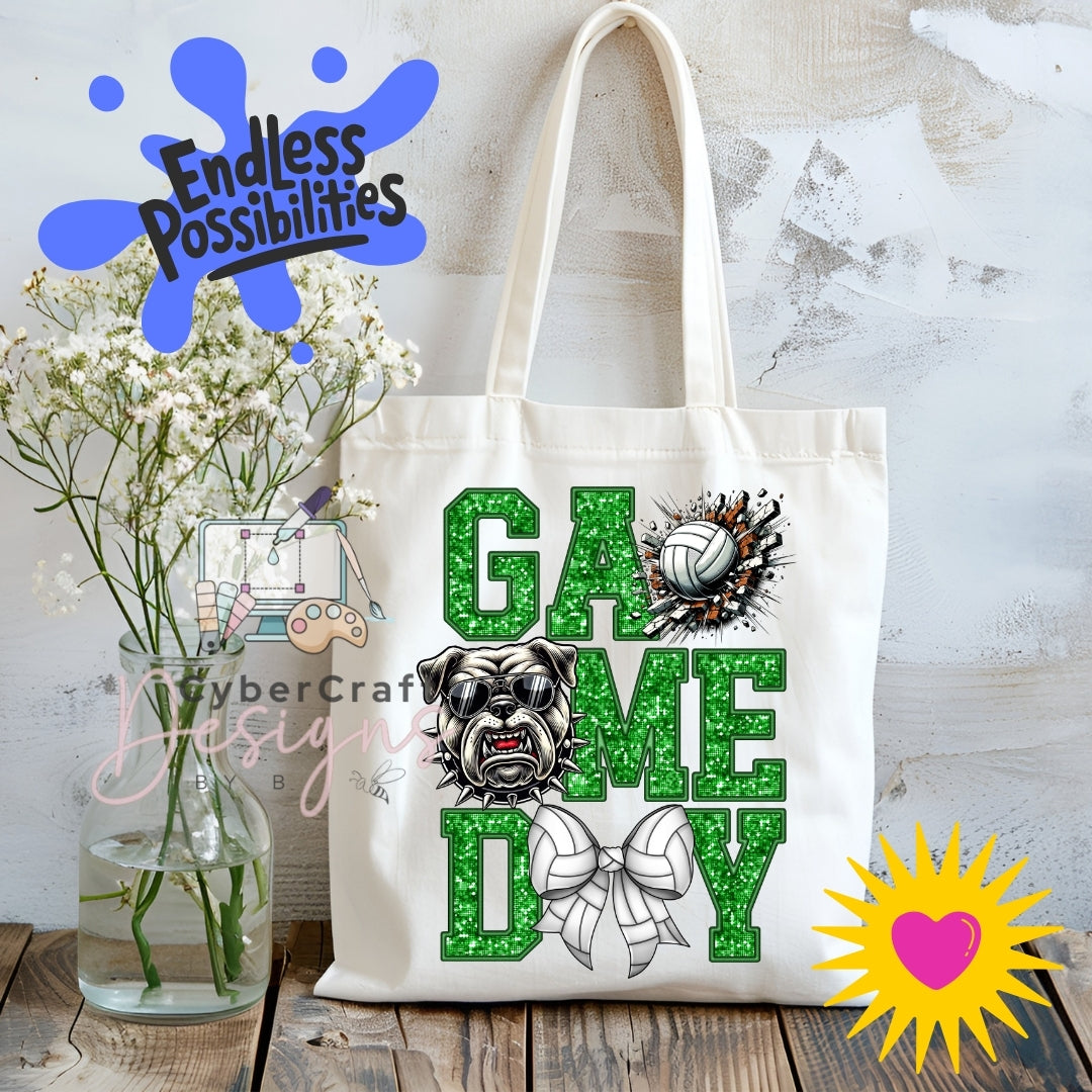 A cream canvas tote bag displayed on a rustic wooden table with white baby's breath flowers in a glass vase. The bag features a green glitter-textured 'GAME DAY' design with a bulldog graphic and a volleyball.