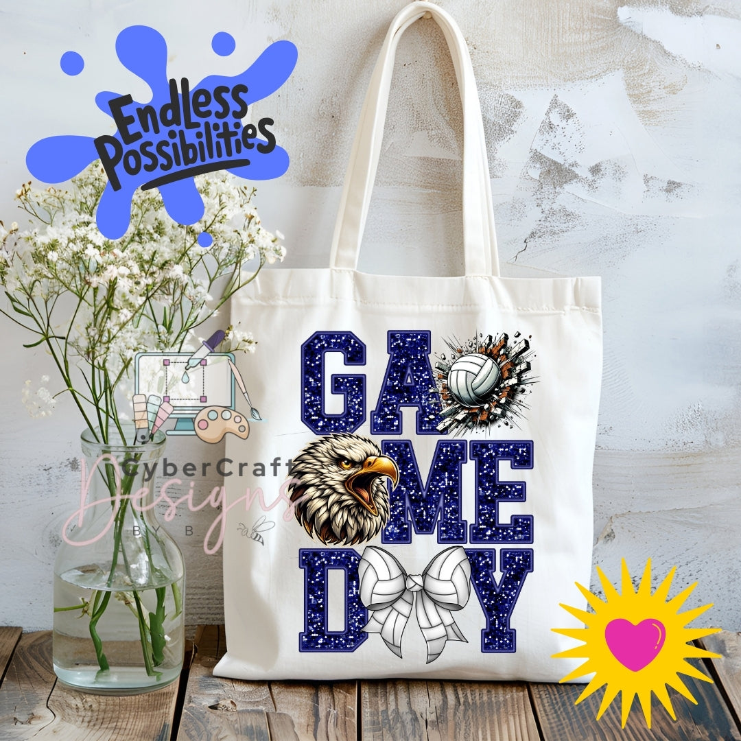 A white canvas tote bag with 'GAME ME DAY' printed in navy blue glitter-style letters, decorated with an eagle head, volleyball, and bow graphic. The bag is displayed on a rustic wooden table next to a glass vase of white flowers, with decorative digital overlays including 'Endless Possibilities' and 'CyberCraft Designs'.