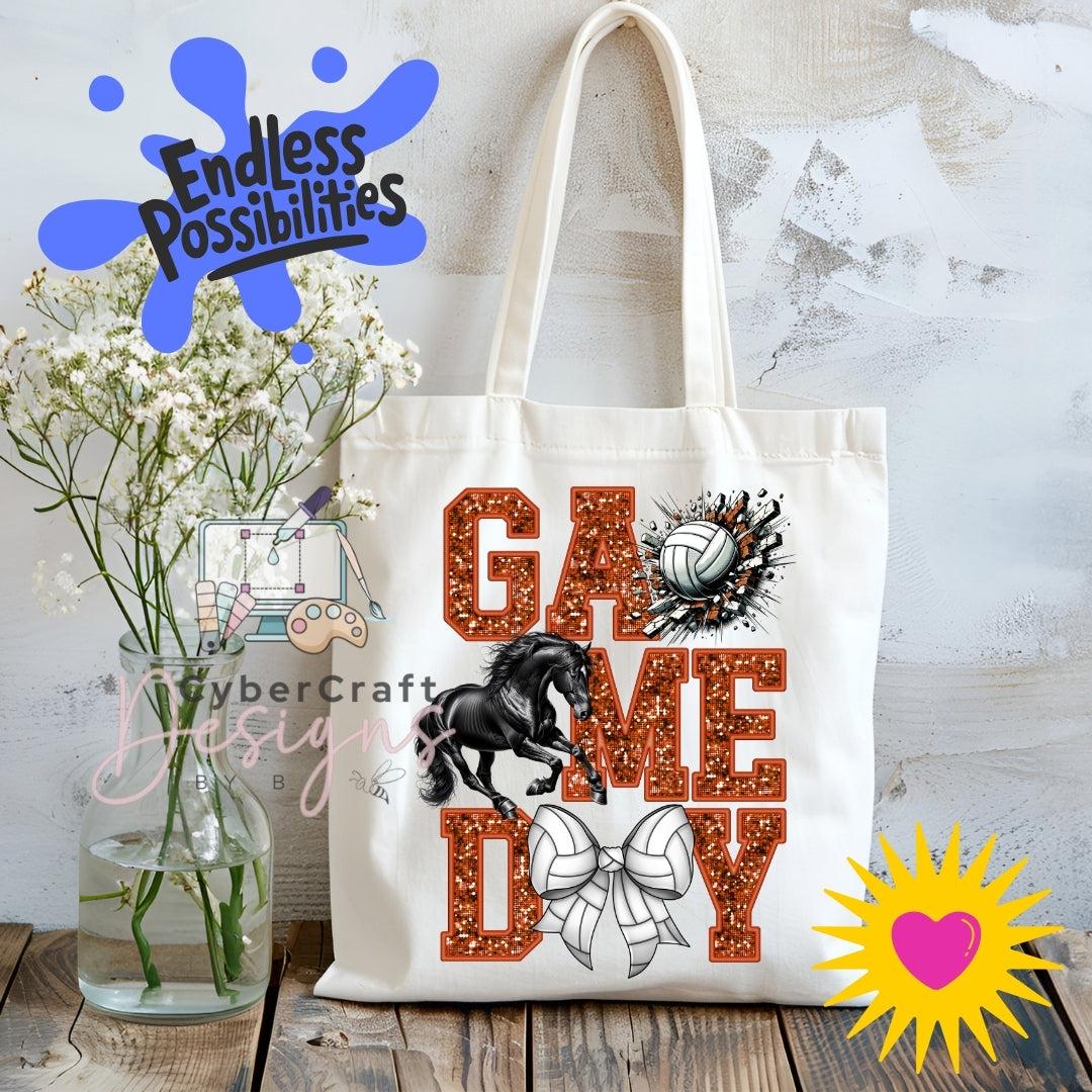 A white canvas tote bag with 'GAME DAY' in glittery orange-brown letters, a black horse graphic, a volleyball, and a white bow, displayed on a wooden surface with flowers and decorative overlays.